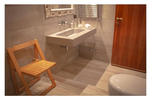 y baño con lavabo, silla y aseo. en Ostia Holiday La Spiaggetta, en Lido di Ostia