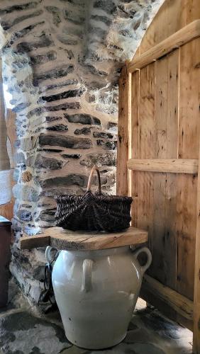 a large white vase with a basket on top of it at La Bergerie du Miravidi in Bourg-Saint-Maurice