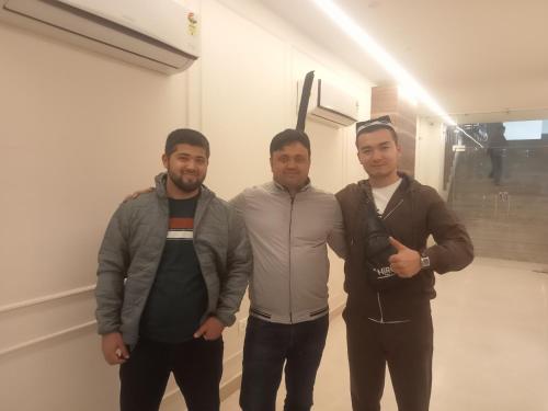 a group of three men standing in a room at HOTEL SHYAM PALACE INDIA AGRA in Agra