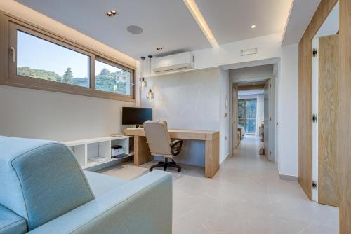 a home office with a desk and a couch at Villa Stafida Kassiopi in Kassiopi