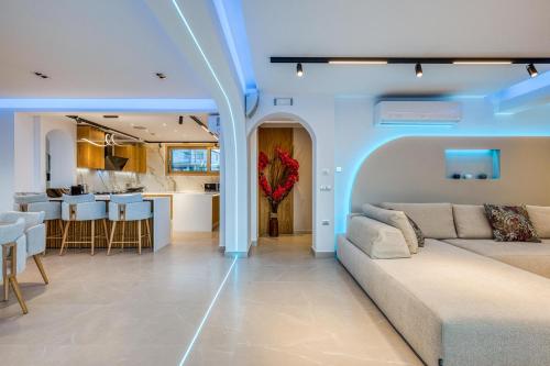 a living room with a couch and a kitchen at Villa Stafida Kassiopi in Kassiopi