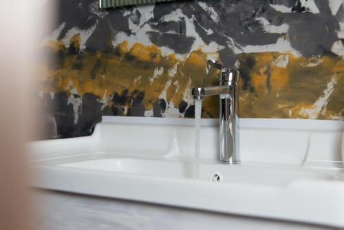 a sink with a faucet in a bathroom at Green Bay Studio 1 in Sifnos