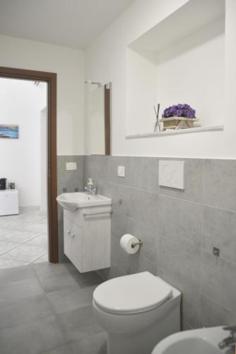 ブリンディジにあるLa via maestraの白いトイレと洗面台のあるバスルーム