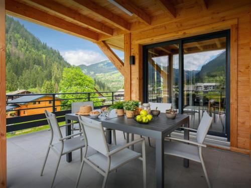 a dining room with a table and chairs on a balcony at Chalet Alphonse - OVO Network in Châtel