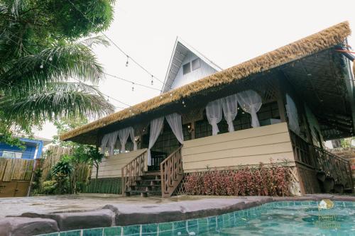 a house with a swimming pool in front of it at Balay sa Gugma in Tagaytay