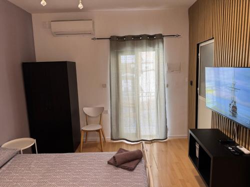 a bedroom with a bed and a flat screen tv at Bentley Floriana Suites in Il-Furjana