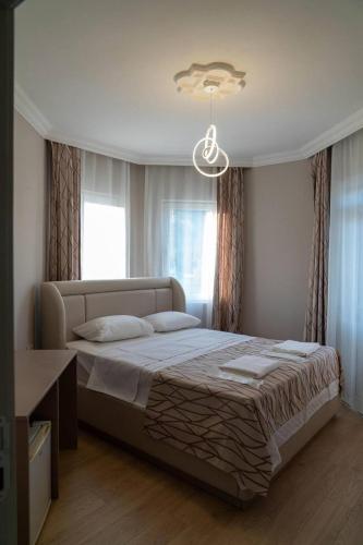 a bedroom with a large bed in front of a window at Green Garden Otel in Kemer
