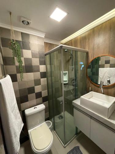 a bathroom with a shower and a toilet and a sink at Taiba Beach Resort 03 Apto 2 quartos in São Gonçalo do Amarante