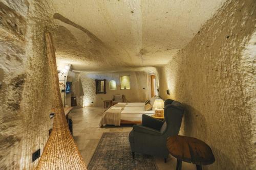 a bedroom with a bed in a stone wall at Vie Cappadocia - Adults Only in Nevsehir