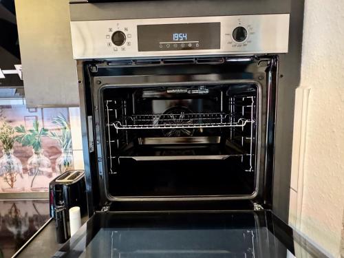 an oven with its door open in a kitchen at Reviernest in Gelsenkirchen