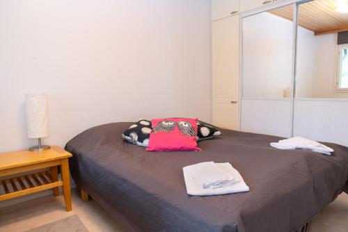 a bedroom with a bed with two towels on it at Lomakatti Apartments in Vuokatti