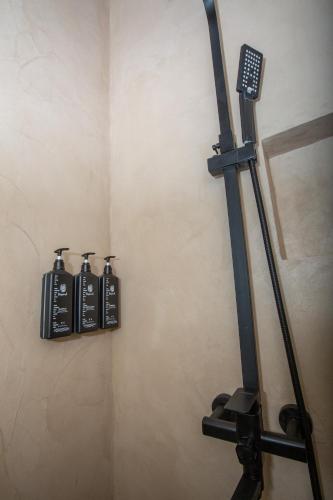 a room with two black bottles on a wall at V la vie in Ioannina