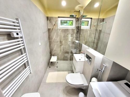 a small bathroom with a toilet and a sink at Apartament Rodzinny Młyńska in Augustów