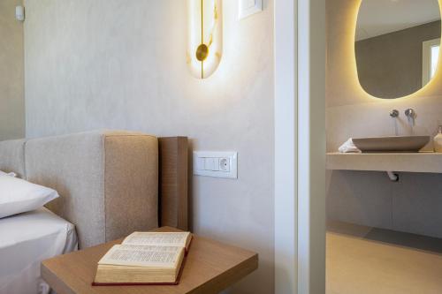 a bedroom with a bed and a table with a book at Elithos Villa in Vryses