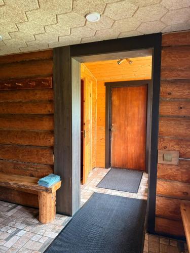 an entrance to a house with a wooden door at Atpūtas vieta Jaunkārkliņi in Karva