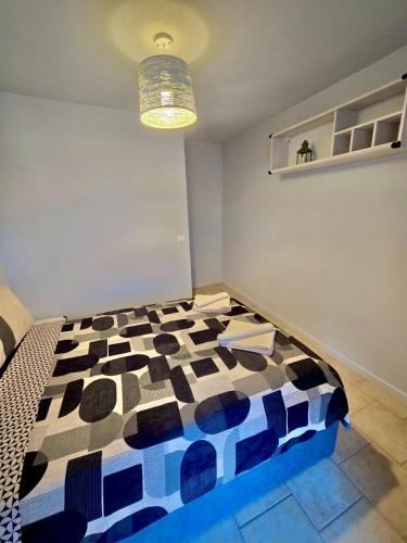 a bedroom with a bed with a black and white comforter at Daisy House Golden Beach Area in Potamia