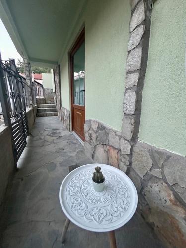 a white table sitting outside of a building at Daisy House Golden Beach Area in Potamia