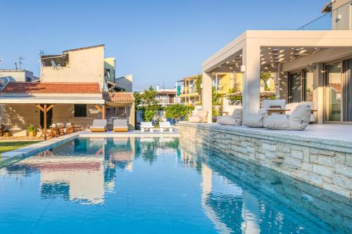 a swimming pool in the middle of a house at Villa Stafida Kassiopi in Kassiopi