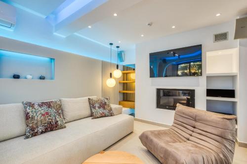 a living room with a couch and a fireplace at Villa Stafida Kassiopi in Kassiopi