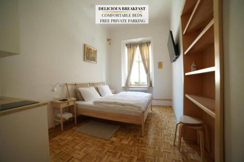 a bedroom with a bed and a table and a window at Sobe Proštija in Ptuj