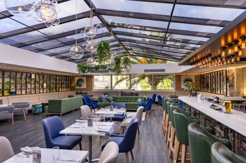 a dining room with tables and chairs at The Cape Milner in Cape Town