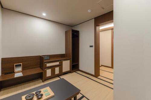 an empty room with a table and a door at Yuhyu Ryokan Hotel in Seoul