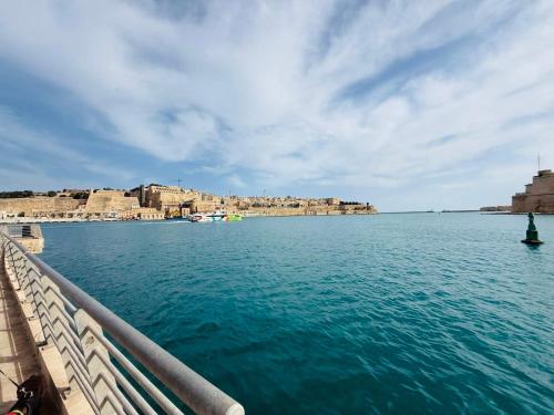 a view of a body of water from a pier at Il-Maxtura - Charming 17th Century House Of Character in the Historical Three Cities in Cospicua