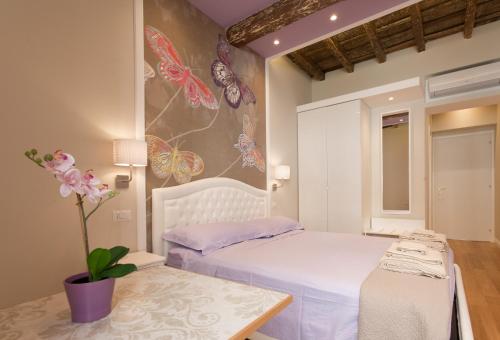 a bedroom with a bed with butterflies on the wall at Boschetto 124 Apartment in Rome