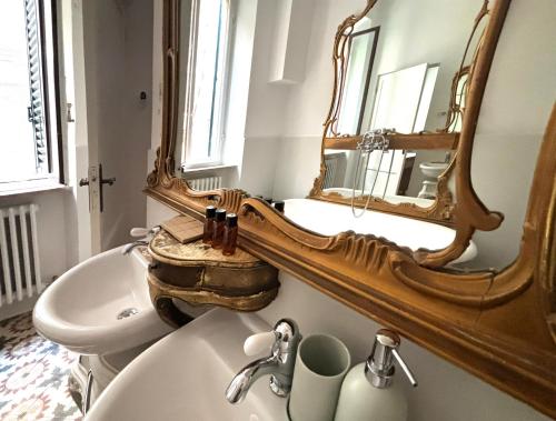 a bathroom with a sink and a mirror on the wall at B&B La Fontanina in Siena