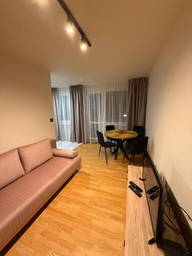 a living room with a couch and a table at Apartament Grodzka in Wałbrzych