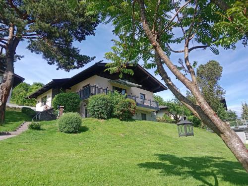 a house on a hill with green grass at Holiday Home Riki by Interhome in Bruck an der Großglocknerstraße