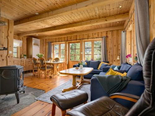 a living room with a blue couch and a table at Holiday Home Myravatnet by Interhome in Viksdalen
