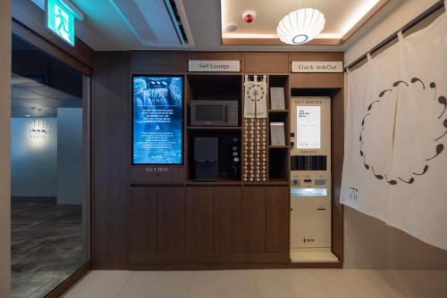 a lobby of a office with a computer on the wall at Yuhyu Ryokan Hotel in Seoul