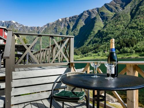 a bottle of wine and two glasses on a table at Holiday Home Eseviki by Interhome in Balestrand