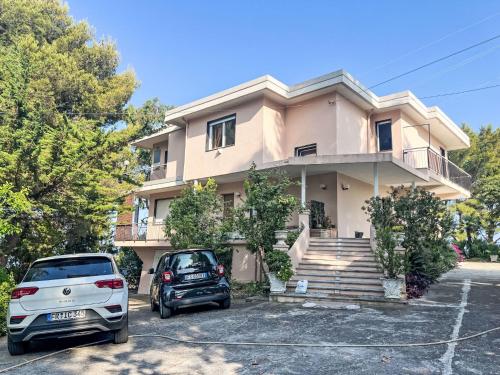 a house with two cars parked in a parking lot at Holiday Home Villa Jose - PGI212 by Interhome in Civezza