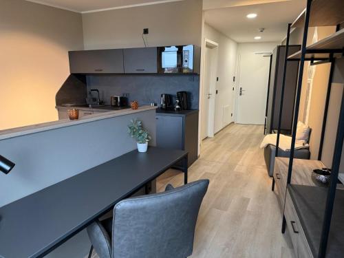 a kitchen and living room with a table and chairs at Exklusives Wohnen im historischen Wasserturm dem Highlight von Delitzsch WE 213 in Delitzsch
