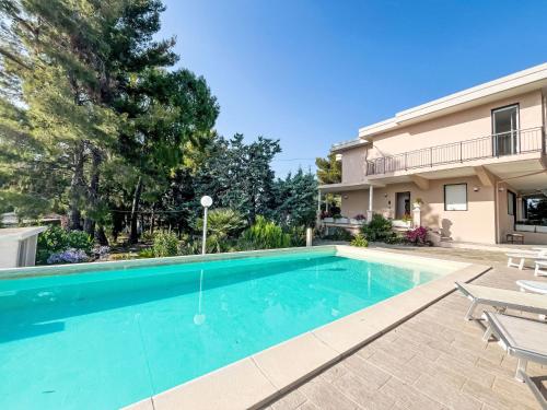 a swimming pool in front of a house at Holiday Home Villa Jose - PGI212 by Interhome in Civezza