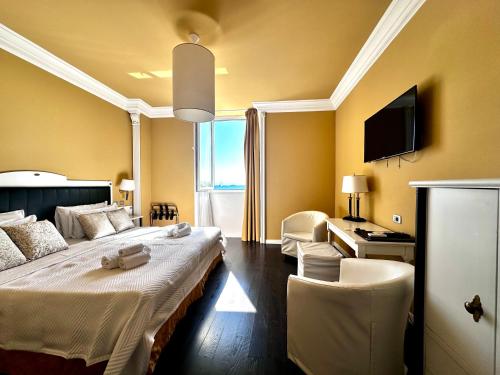 a hotel room with a large bed and a desk at Greif Hotel & Spa in Trieste