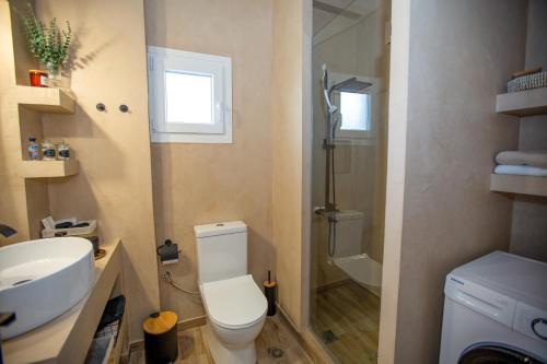 a bathroom with a toilet and a sink and a shower at V la vie in Ioannina