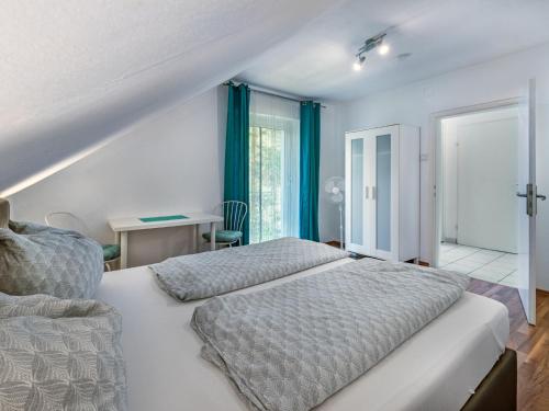 a white bedroom with a bed and a window at Apartment Ogris-2 by Interhome in Selpritsch