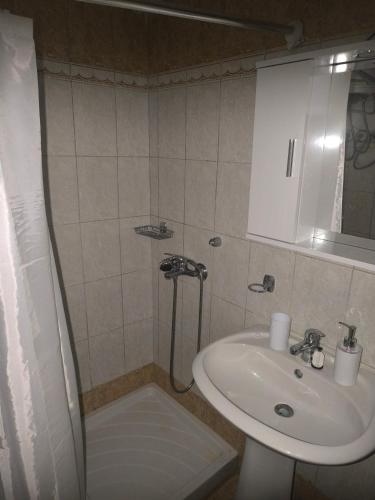 a small bathroom with a sink and a shower at Johanna's apartment in Preveza