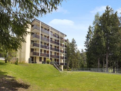 an apartment building with a lawn in front of it at Apartment Allod Park Haus C 404 by Interhome in Davos