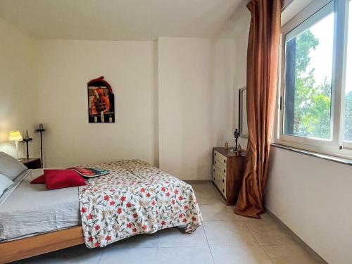a bedroom with a bed and a window at Apartment Arancio di Liguria - PGI211 by Interhome in Civezza