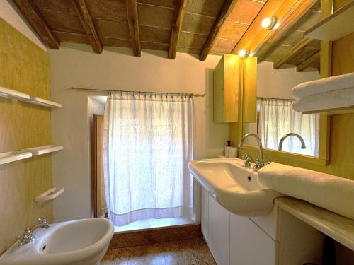 a bathroom with a sink and a mirror and a window at Le terrazze di Camollia in Siena