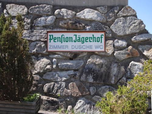 a street sign on a stone wall at Apartment Jägerhof-3 by Interhome in Hochpillberg