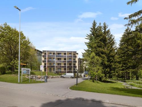 an apartment building in a park with a street light at Apartment Allod Park Haus C 202 by Interhome in Davos