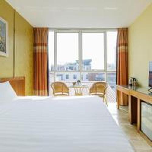 a hotel room with a large bed and a large window at Dancenter Near Hoan Kiem Lake, Vincom Center Ba Trieu Formerly Le Grand The Sun in Hanoi