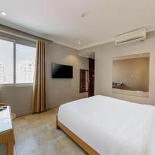 a bedroom with a large white bed and a window at Dancenter Near Hoan Kiem Lake, Vincom Center Ba Trieu Formerly Le Grand The Sun in Hanoi