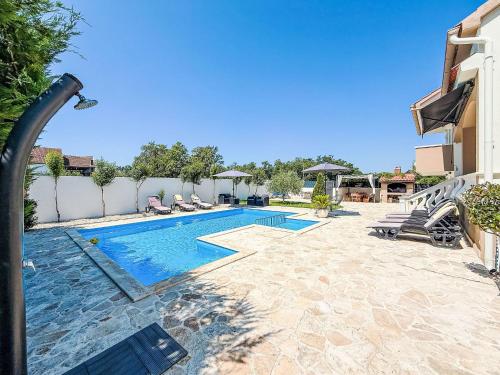 a swimming pool in the middle of a yard at Holiday Home Tina & Tino by Interhome in Briševo