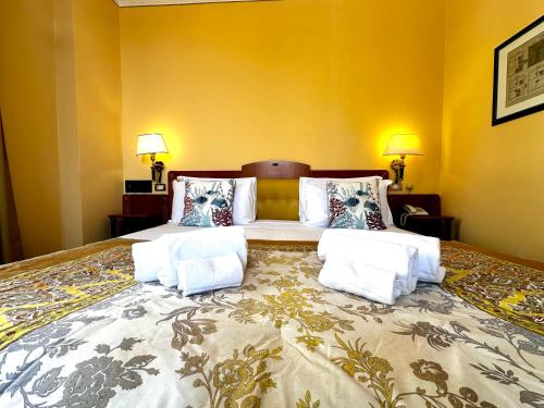 a bedroom with a large bed with two pillows at Greif Hotel & Spa in Trieste
